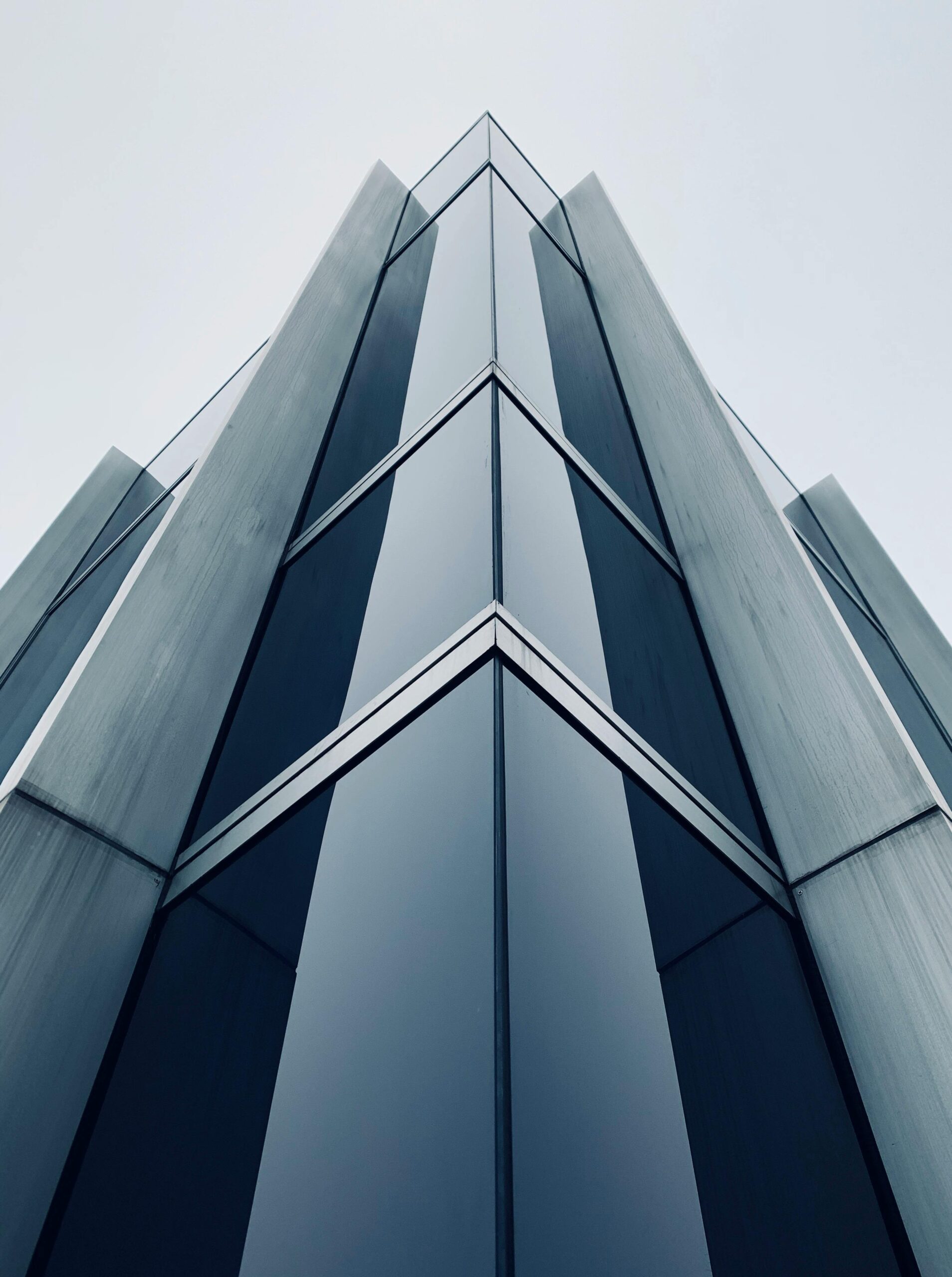 Low-angle shot of a sleek, modern skyscraper in Zürich, showcasing its glass and steel exterior.